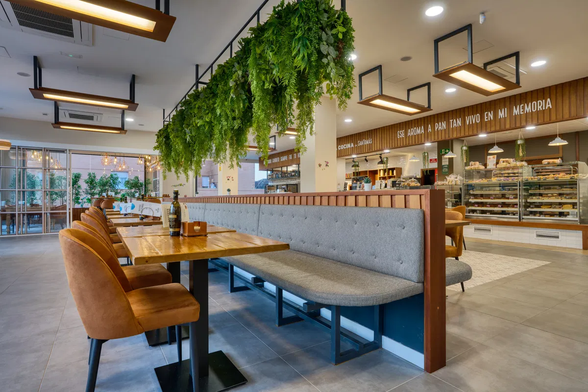 Banco corrido de respaldo alto usado como separador de ambientes en un restaurante — MisterWils